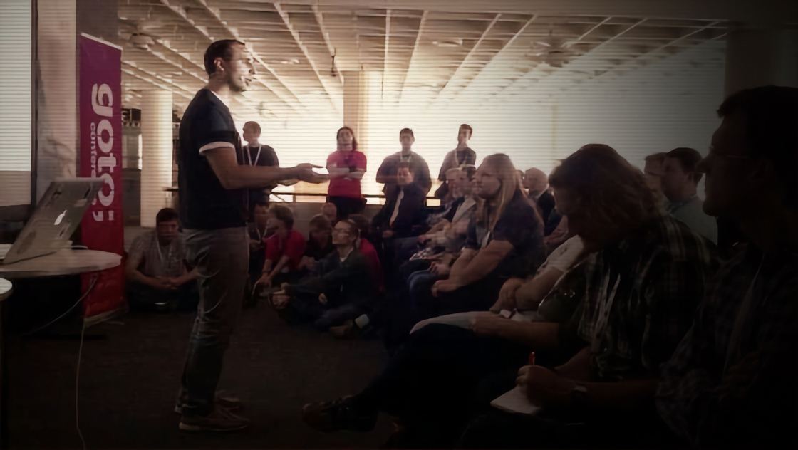 Enrico presenting to a seated audience at GOTO